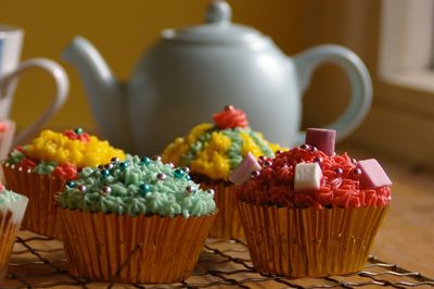 Close-up of cupcakes and teapot