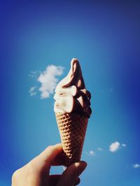 Cropped hand holding ice cream cone