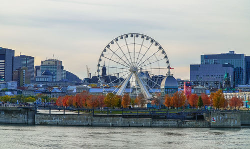 Ferris wheel in city against sky