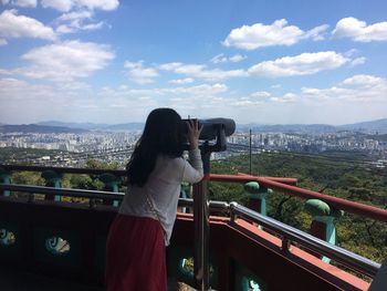 Woman photographing cityscape