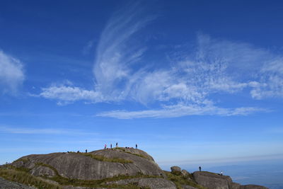 Low angle view of mountain against blue sky