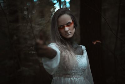 Portrait of a beautiful young woman standing outdoors