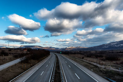 View of highway against cloudy sky