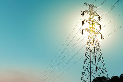Low angle view of electricity pylon against sky
