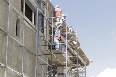 Low angle view of man working at construction site