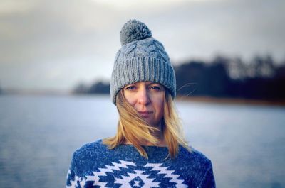 Close-up portrait of woman wearing knit hat