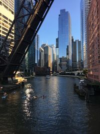 Bridge over river against buildings