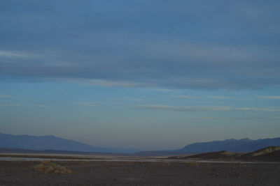 Scenic view of landscape against blue sky