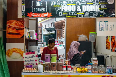 Man for sale at market stall