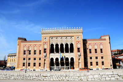 Low angle view of historical building against blue sky