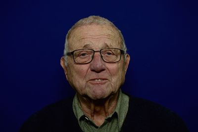 Portrait of man against blue background