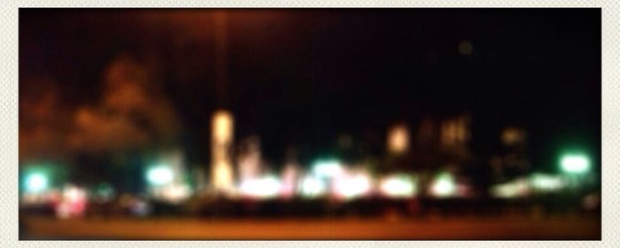 Defocused image of illuminated city at night