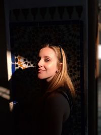 Portrait of young woman looking at window