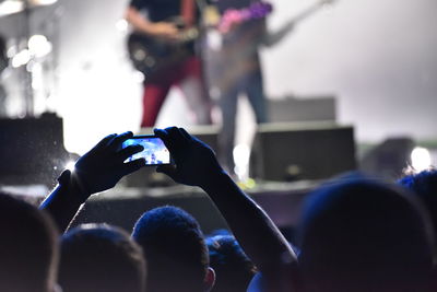 People photographing at music concert