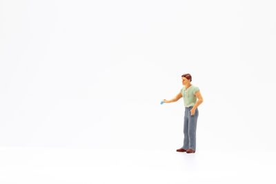 Full length portrait of man standing against white background