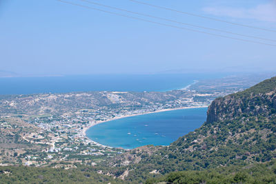 Aerial view of sea and city against sky