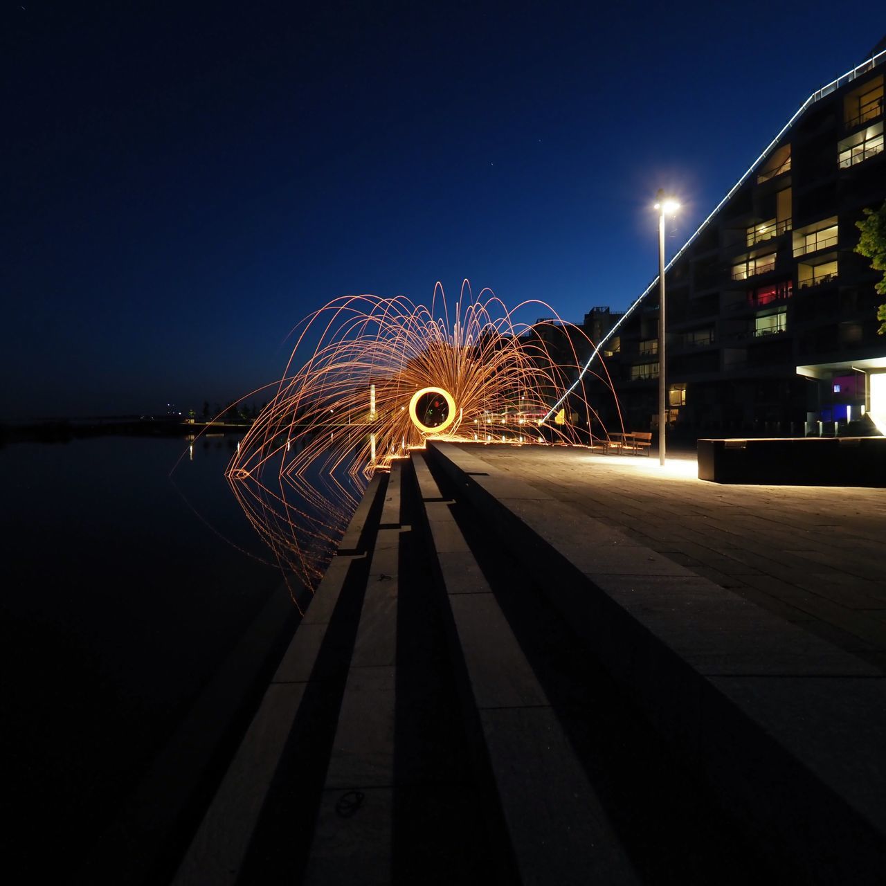 night, illuminated, motion, architecture, blurred motion, long exposure, sky, built structure, glowing, clear sky, nature, building exterior, spinning, city, no people, arts culture and entertainment, speed, outdoors, copy space, wire wool