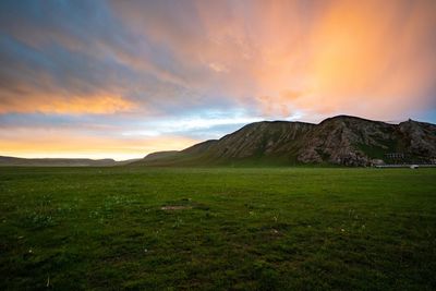 Scenic view of field against sky during sunset