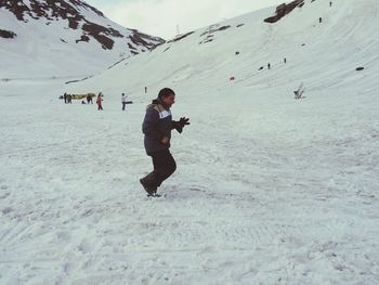 Full length of man on snowcapped mountain