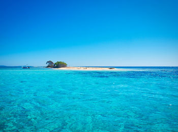 Scenic view of sea against clear blue sky