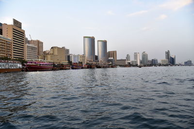 Dubai skyline from dubai creek harbour and dubai canal to downtown and business bay, uae