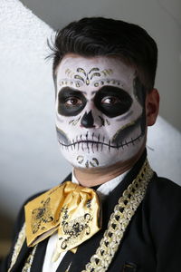 Portrait of young man with face paint