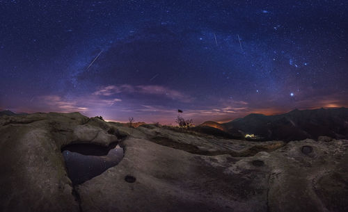 Scenic view of mountains against sky at night