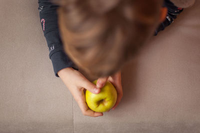 High angle view of boys holding apple