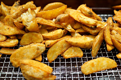 Close-up of french fries on cooling rack