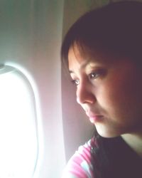 Close-up portrait of young woman looking away