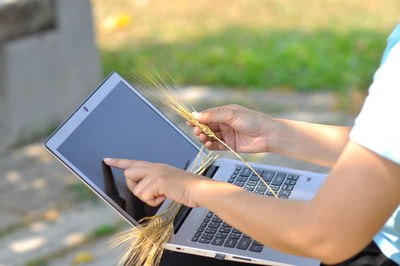 Midsection of person using mobile phone