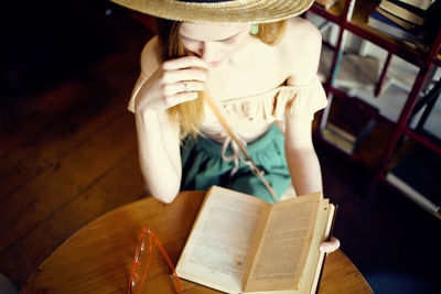 Midsection of woman reading book