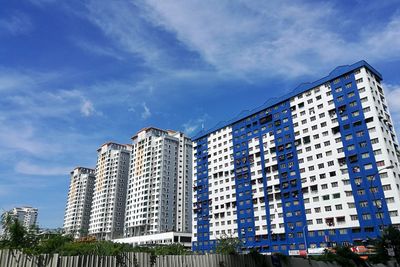 Low angle view of buildings against blue sky