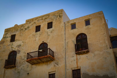 Low angle view of old building against blue sky