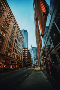 Street amidst buildings against sky in city