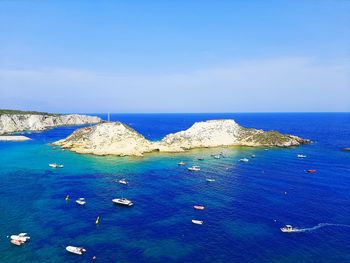 High angle view of sailboats in sea against sky