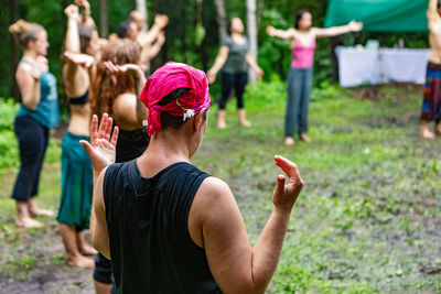 Rear view of people playing outdoors