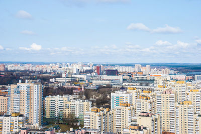 Aerial view of cityscape by sea against sky