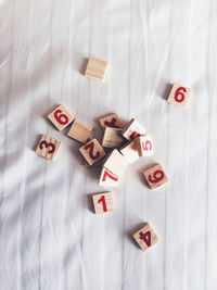 Directly above shot of toy blocks with numbers on bed