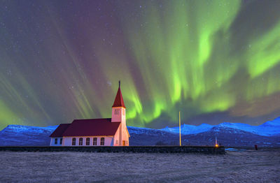 Built structure on illuminated building against sky at night