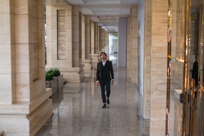 Portrait of man standing in corridor of building