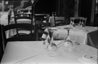 Close-up of empty wineglasses and plates on dining table