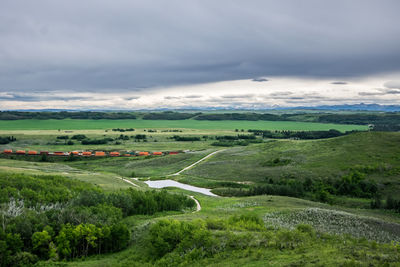 Scenic view of green landscape against sky