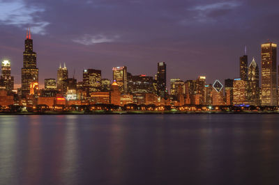 Illuminated city at waterfront