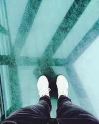 Low section of woman standing on tiled floor