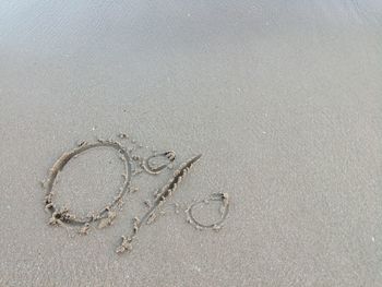 High angle view of heart shape on sand at beach