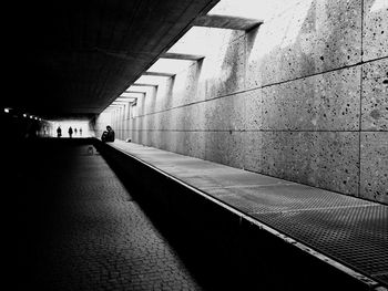 Man walking in corridor of building