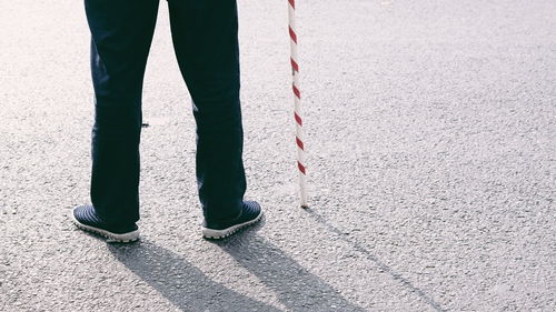 Low section of person standing on footpath