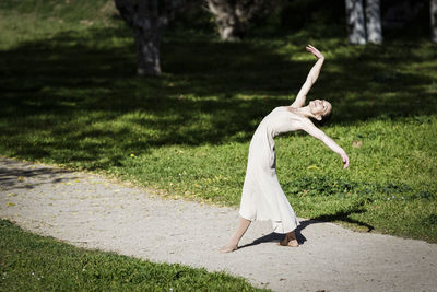 Full length of woman dancing at park