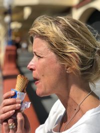 Close-up side view of woman eating ice cream